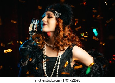 Portrait Of Vintage Styled Woman Dressed In Great Gatsby Era Dancing Under Confetti Rain On Velours Background. Roaring Twenties, Retro, Party, Fashion Concept