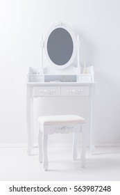 Portrait Of Vintage Vanity Table Mirror Set With Stool And Accessories On White Wall