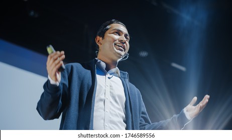 Portrait of Visionary Speaker Presenting New Product, Shows Infographics, Statistics Animation on Screen, Talks About Device Performance. Live Event Device Release Start-up Conference. Low Angle