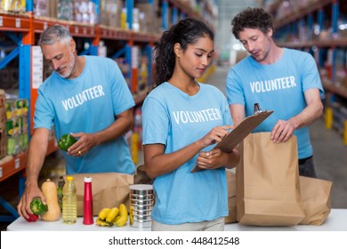 Portrait Of Volunteers Working In A Warehouse