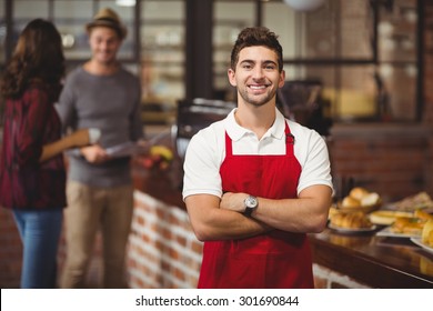 Portrait of a waiter with arms crossed at the coffee shop - Powered by Shutterstock