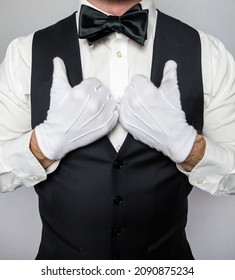 Portrait Of Waiter Or Butler  In Black Waistcoat And White Gloves Standing Elegantly. Concept Of Service Industry And First Class Hospitality.