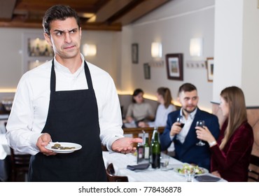 Portrait Of Waiter Dissatisfied With Small Tip From Cafe Visitors 