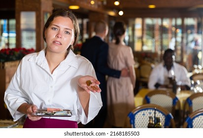 Portrait Of Waiter Upset With Little Tips At Restaurant