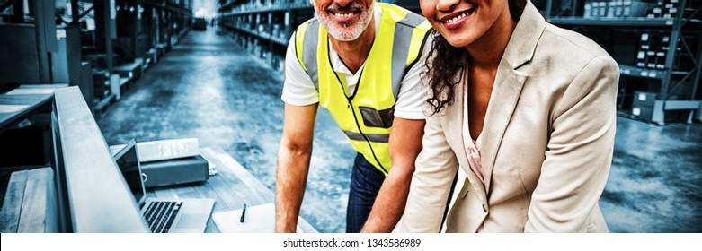 Portrait Of Warehouse Manager And Worker Working Together In Warehouse Office