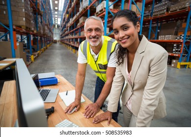 Portrait Of Warehouse Manager And Worker Working Together In Warehouse Office