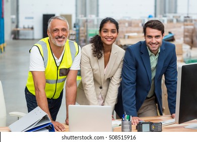 Portrait Of Warehouse Managers And Worker Working Together In Warehouse Office