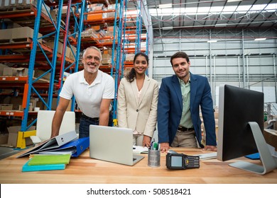 Portrait Of Warehouse Managers And Worker Working Together In Warehouse Office