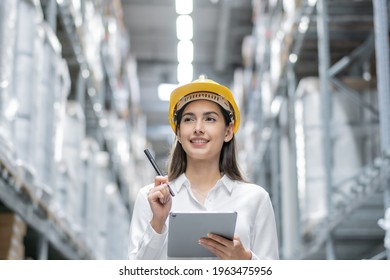 Portrait of warehouse woman worker using digital tablet checking information of stock product inventory on shelf at distribution factory. logistic business shipping and delivery service