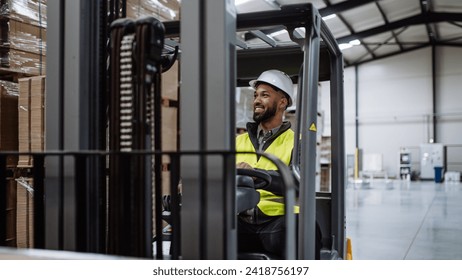 Portrait of warehouse worker driving forklift. Warehouse worker preparing products for shipmennt, delivery, checking stock in warehouse. Banner with copy space. - Powered by Shutterstock