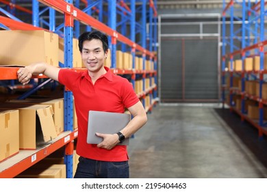 Portrait Of Warehouse Workers Young Asian Man Standing And Using Computer While Looking At Camera And Controlling Stock And Inventory In Retail Warehouse Logistics, Distribution Center