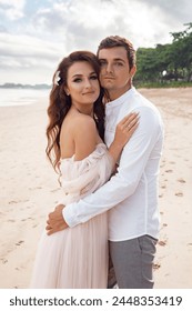 Portrait of white bride and groom at the beach