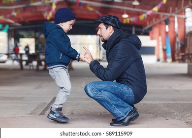 Portrait Of White Caucasian Father And Son Talking To Each Other, Family Of Two, Lifestyle Outside On A Spring Autumn Day