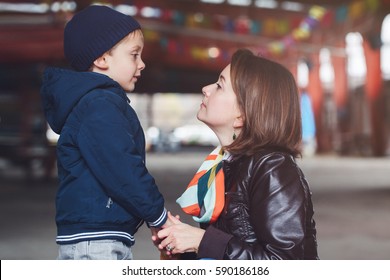 Portrait Of White Caucasian Mother And Son Talking To Each Other, Happy Family Of Two, Lifestyle Outside On A Spring Autumn Day