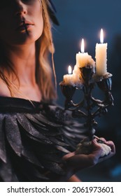 portrait of a witch with candle. Halloween mystical atmosphere. Celtic mythology goddess Valkyrie. Spiritualism spell rite. Masquerade makeup costume. Magic witchcraft occultism. Mystic mood lifestyle