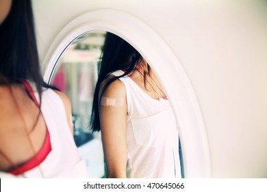 Portrait Of Woman After Flu Shot Vaccine Immunization With Bandaid On Arm Young Person Reflecting In Mirror COVID-19