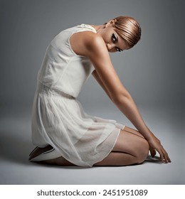 Portrait, woman and ballet in dress at studio on isolated white background, kneeling and makeup for performance. Female person, dancer and performer or artist with practice for concert with fashion - Powered by Shutterstock