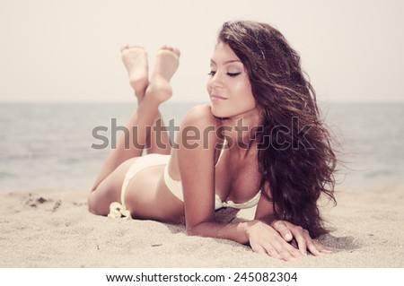 Portrait of a woman with beautiful body on a tropical beach 
