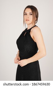 Portrait of woman in black dress in studio