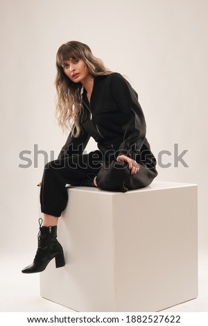 Portrait of woman in black outfit in studio