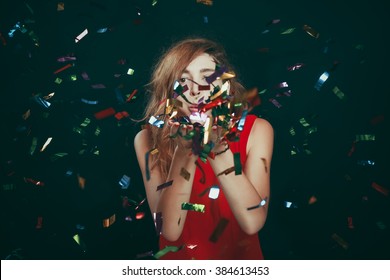 Portrait Of Woman Blowing Confetti