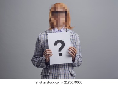 Portrait of woman with blurred face, she is holding a sign with a question mark