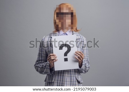 Portrait of woman with blurred face, she is holding a sign with a question mark