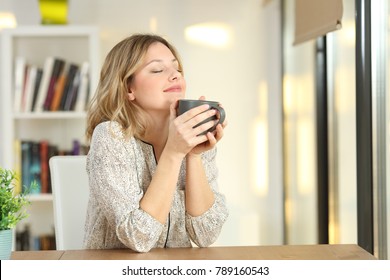 Portrait of a woman breathing and holding a coffee mug at home - Powered by Shutterstock