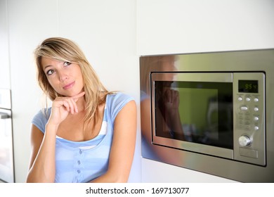 Portrait Of Woman By Microwave Oven