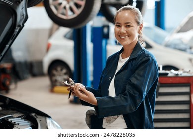 Portrait, woman or car mechanic with clipboard for writing, maintenance and engine inspection in workshop. Repair shop, service and female expert with checklist, auto experience and notes in garage - Powered by Shutterstock