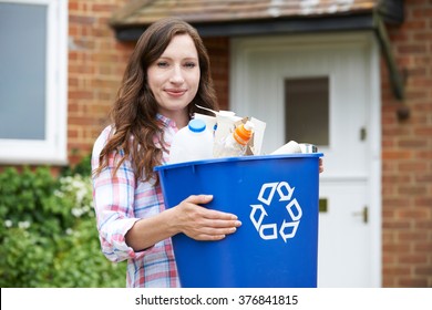 Portrait Of Woman Carrying Recycling Bin