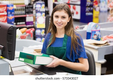 Portrait Of Woman Cashier Smiling At Checkout