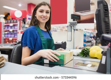 Portrait Of Woman Cashier Smiling At Checkout