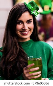 Portrait Of Woman Celebrating St Patricks Day With A Green Pint