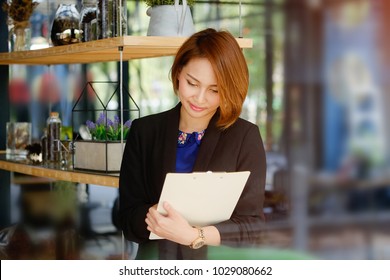 Portrait woman checklist on clipboard with business secretary.