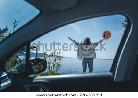 Portrait woman cheerful raising her hands up and feeling happiness, Happy cheerful young woman traveling on the sea by car.