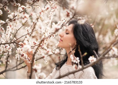 Portrait Of A Woman In A Cherry Blossom Garden