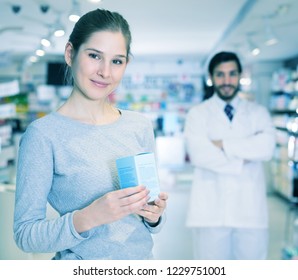 Portrait of woman client who is satisfied of recommended medicines in chemist's shop