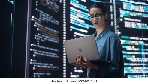 Portrait of Woman Creating a Software and Coding, Surrounded by Big Screens Displaying Lines of Programming Language Code. Female Programmer Working in a Monitoring Control Room. Futuristic Concept