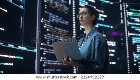 Portrait of Woman Creating a Software and Coding, Surrounded by Big Screens Displaying Lines of Programming Language Code. Female Programmer Working in a Monitoring Room. Futuristic Concept