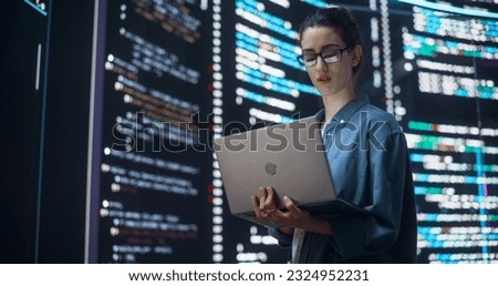 Portrait of Woman Creating a Software and Coding, Surrounded by Big Screens Displaying Lines of Programming Language Code. Female Programmer Working in a Monitoring Control Room. Futuristic Concept