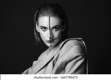 Portrait Of A Woman With A Creative Red Striped Make Up. Fashion Photography In Black And White Tones. High Contrast And Dark Background With A Copyspace