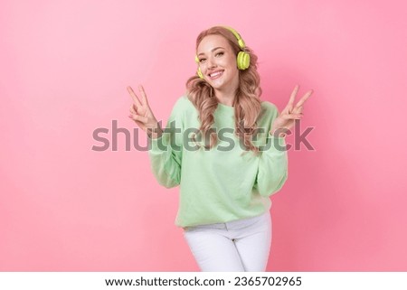 Portrait of woman dancing two hands v sign demonstrate her peace chill listen wireless headphones apple isolated on pink color background