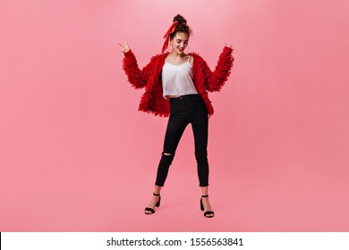 Portrait of woman in dark pants and red coat dancing on isolated background - Powered by Shutterstock