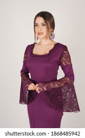 Portrait Of Woman In Dark Purple Dress In Studio