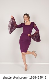 Portrait Of Woman In Dark Purple Dress In Studio