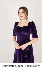 Portrait Of Woman In Dark Purple Dress In Studio