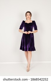 Portrait Of Woman In Dark Purple Dress In Studio