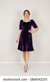 Portrait Of Woman In Dark Purple Dress In Studio