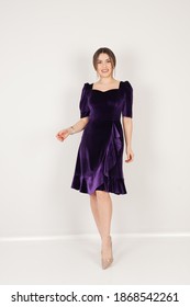 Portrait Of Woman In Dark Purple Dress In Studio